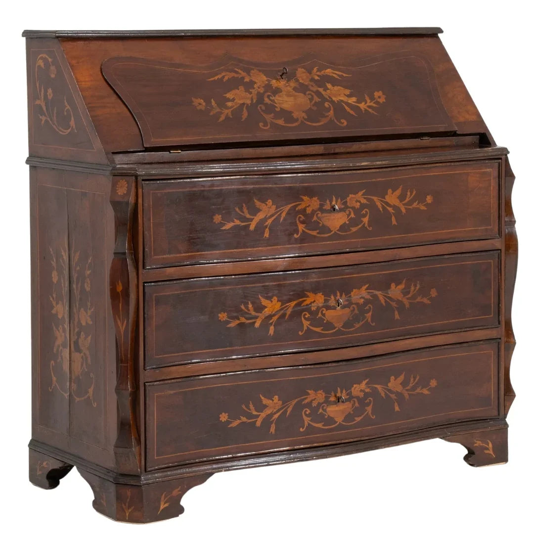 Antique brown wooden slant-front secretary desk with floral marquetry inlay and three drawers.