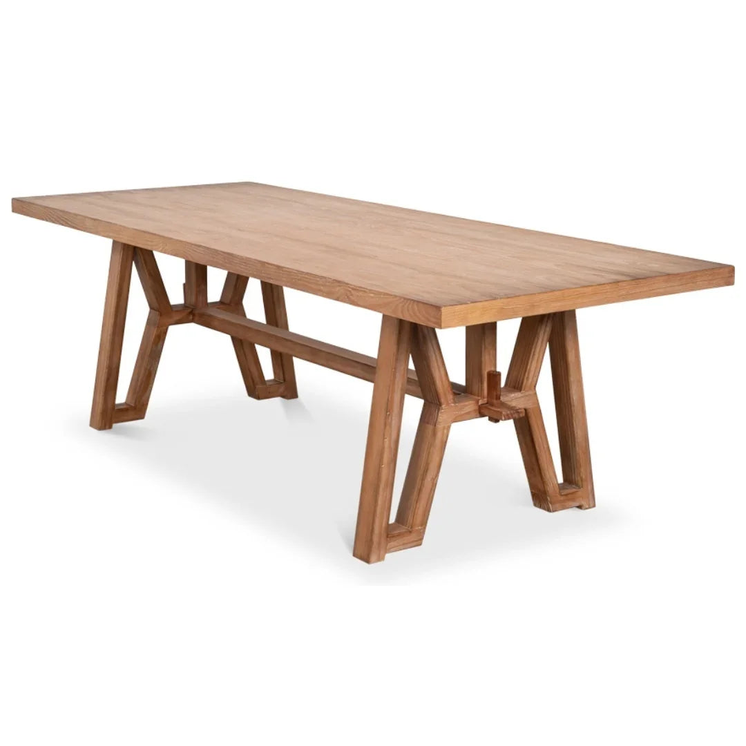 Natural wood farmhouse dining table with trestle base in a rustic boho style.