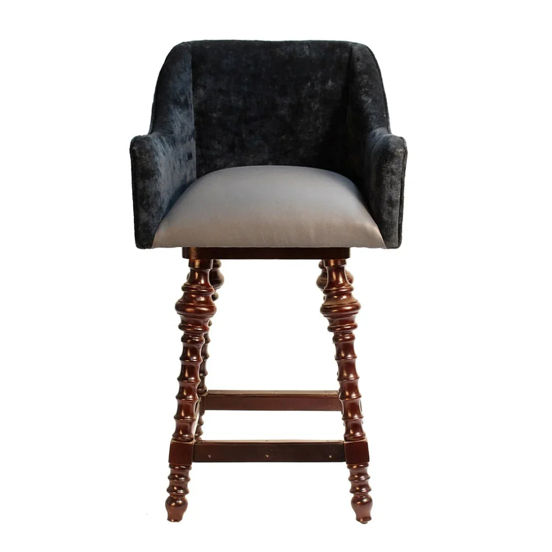 Dark grey velvet bar stool with a light grey seat and carved wooden legs in a classic style.