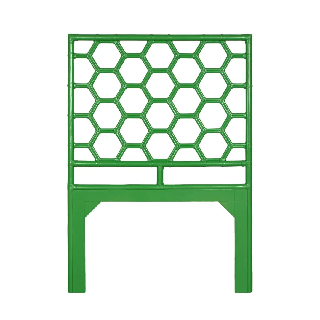 Green bamboo style headboard with a honeycomb lattice design in a coastal style.