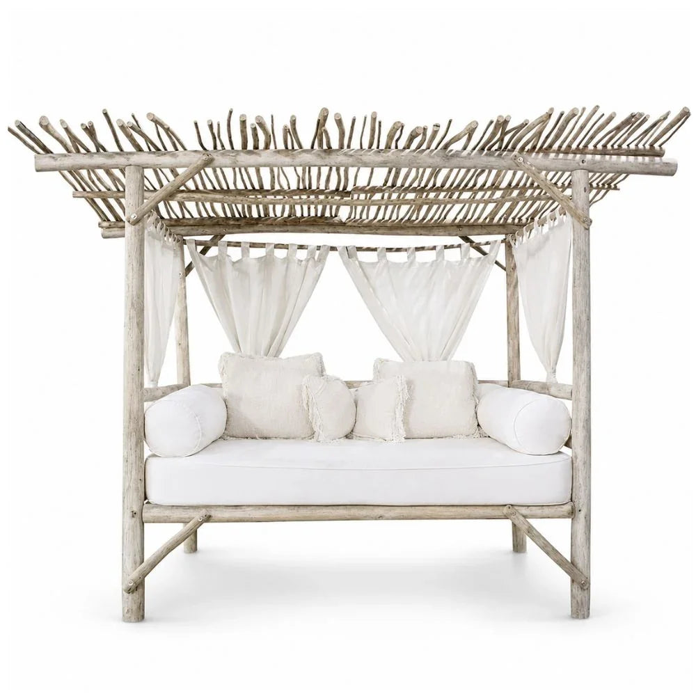 Rustic driftwood canopy daybed with white cushions, coastal boho style outdoor furniture