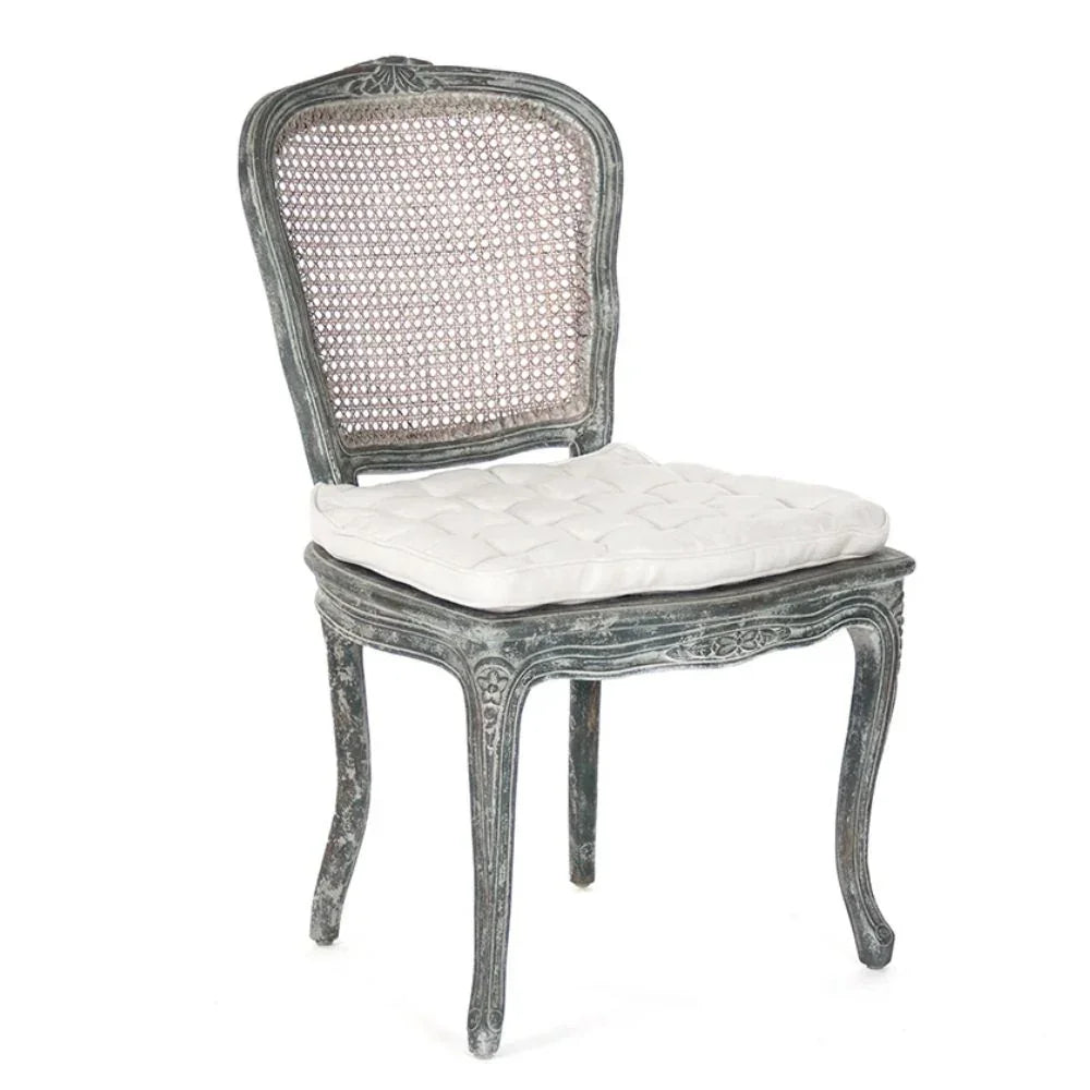 Distressed gray French country cane back chair with white tufted cushion, shabby chic style