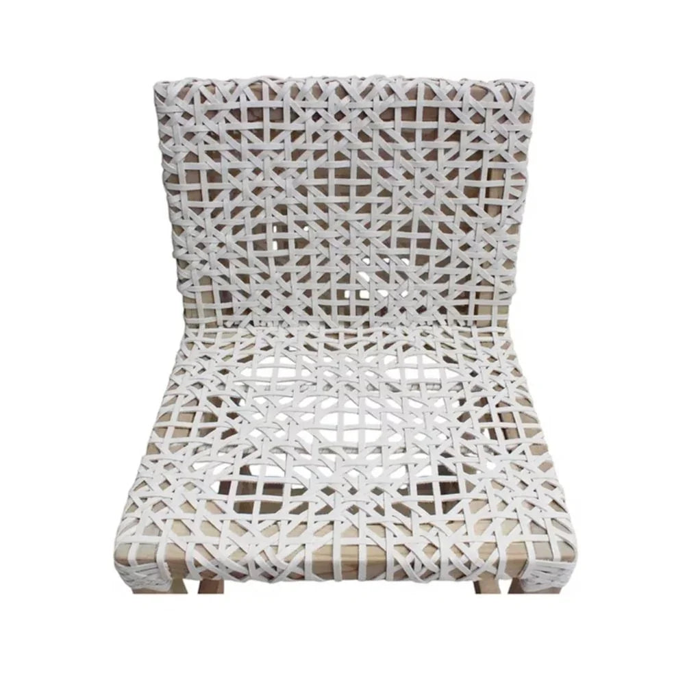White woven rattan chair with geometric pattern, coastal boho style seating
