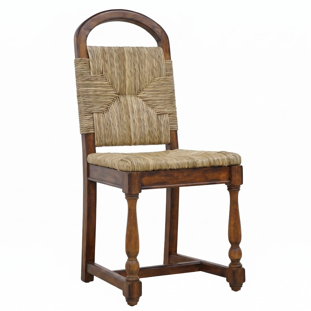Marceau mango wood dining chair with woven natural fiber seat, arched backrest, and turned legs.