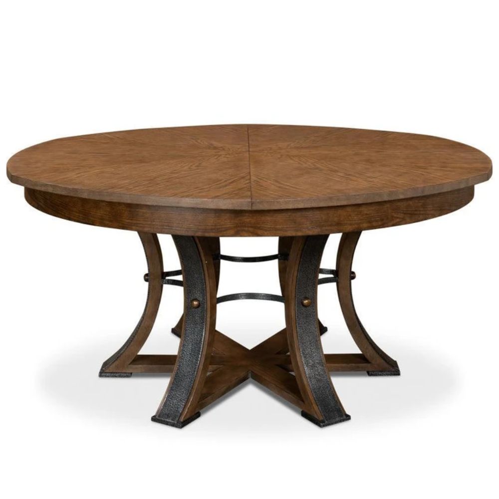 Brown round farmhouse dining table with a pedestal base and metal accents.