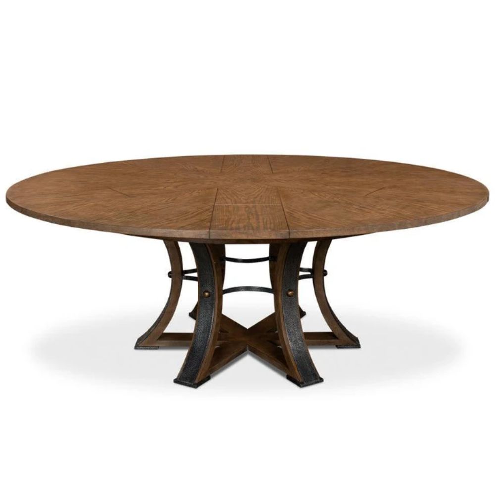 Round oak farmhouse dining table with a dark pedestal base and expanded top.