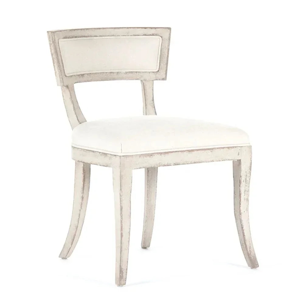 Elegant shabby chic dining chair with distressed white finish and cream upholstery, perfect for French country decor