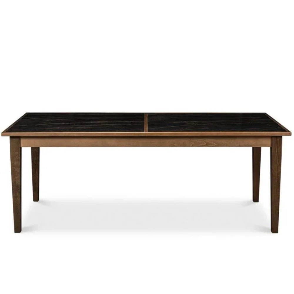 A rectangular wooden dining table with a dark black-and-charcoal patterned top and medium brown wood frame and legs, shown against a plain white background.