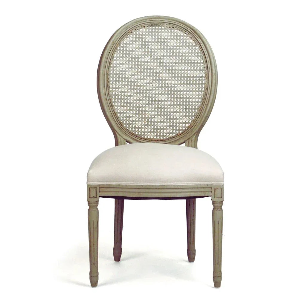 French country oval cane back dining chair with cream upholstered seat in distressed sage green.