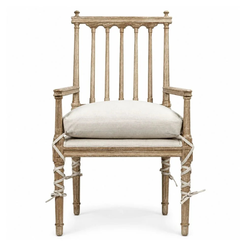 Rustic French country wooden armchair with cream cushion and rope detail.