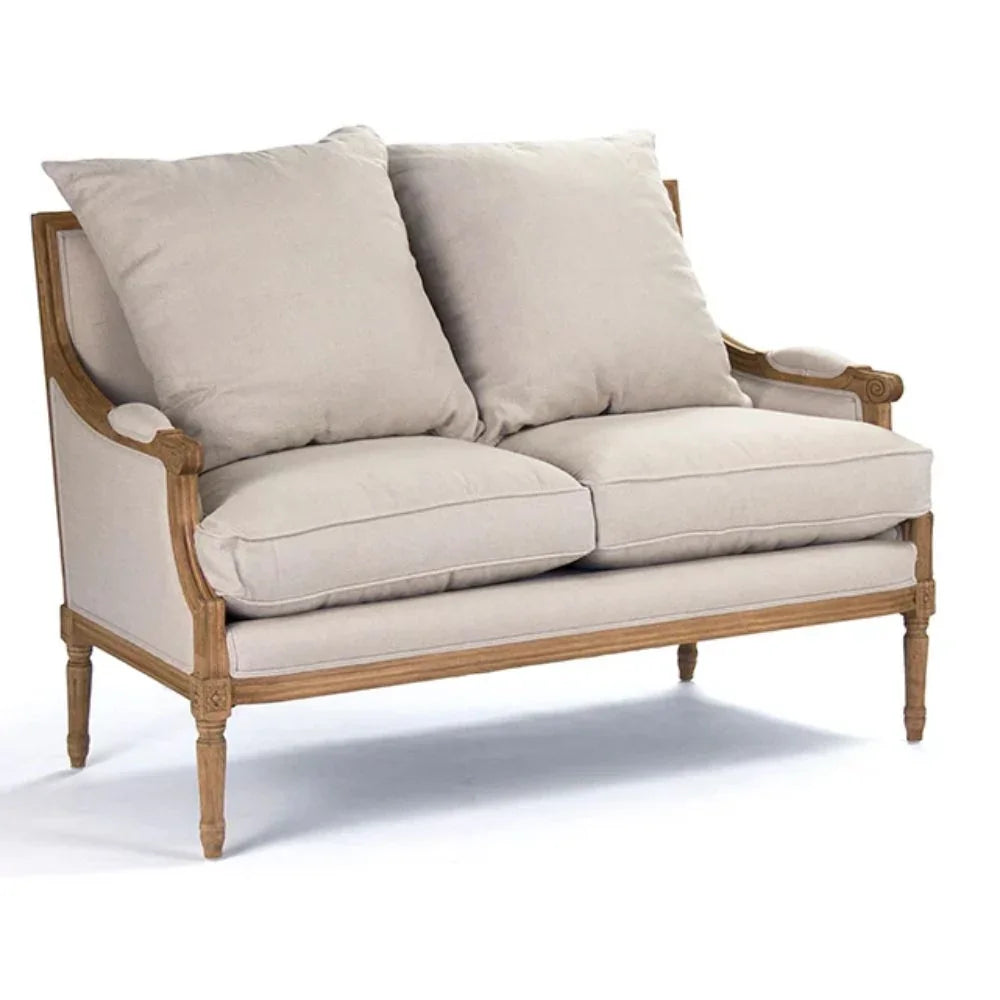 French country loveseat with beige upholstery and carved wood frame, perfect for shabby chic or farmhouse decor