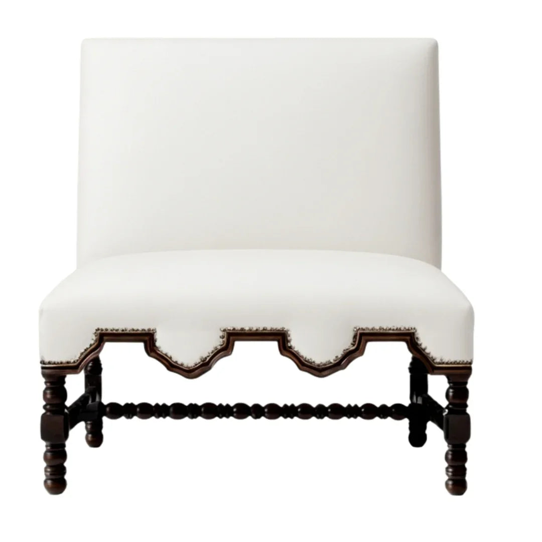 Elegant white upholstered accent chair with dark wood carved legs in French country style.