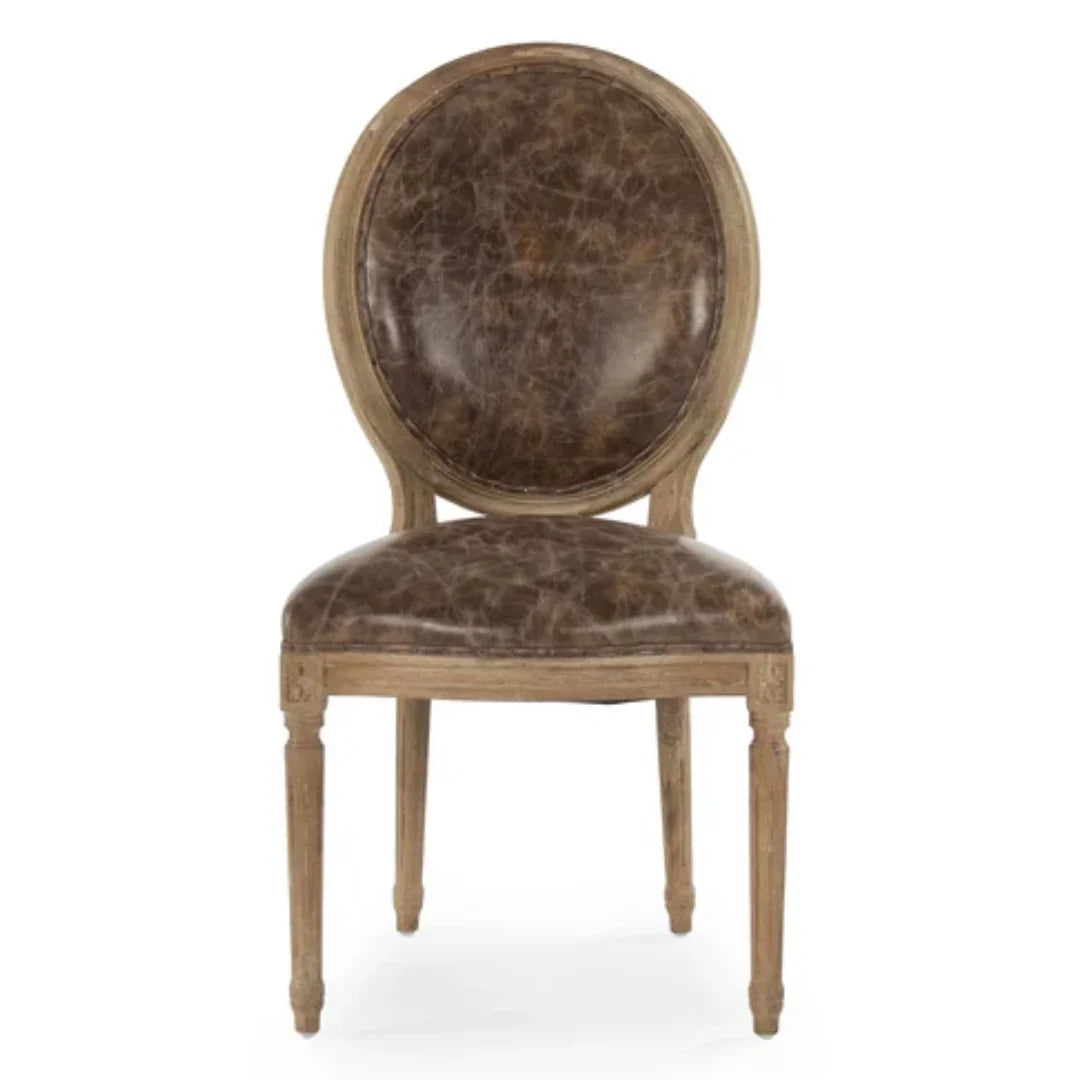 Brown distressed leather oval back dining chair in a French country farmhouse style.
