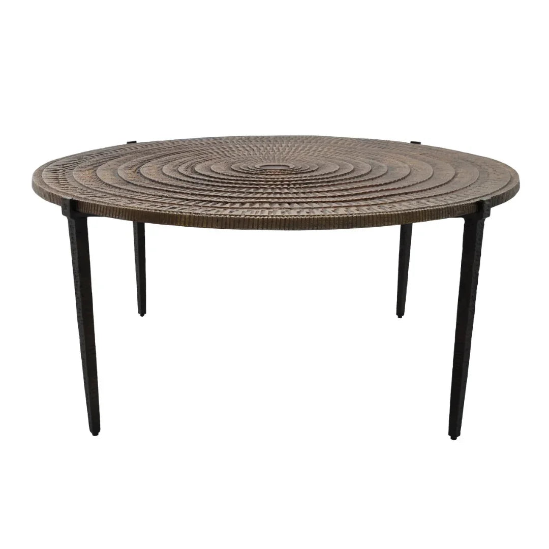 Round wicker coffee table with concentric circle design and black metal legs, coastal boho style
