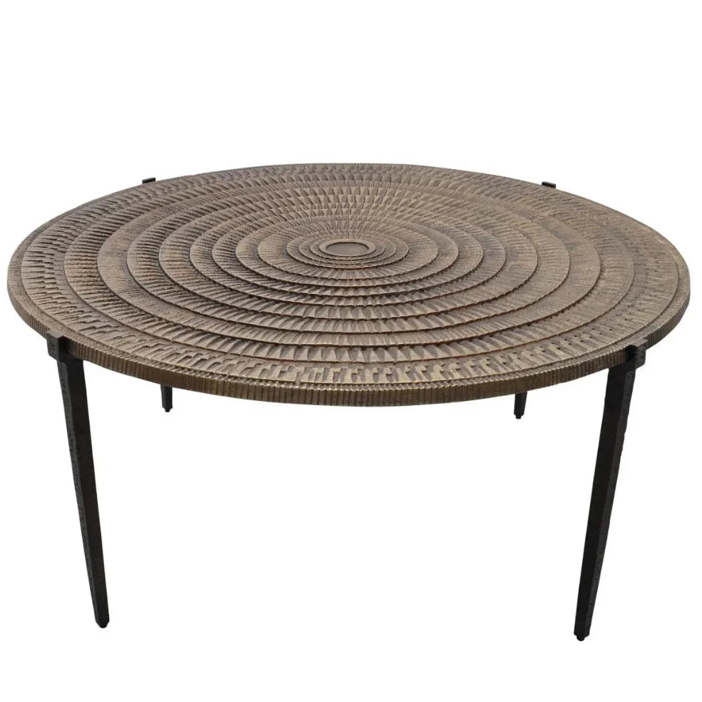 Round wicker coffee table with concentric circle pattern and black metal legs, boho coastal style