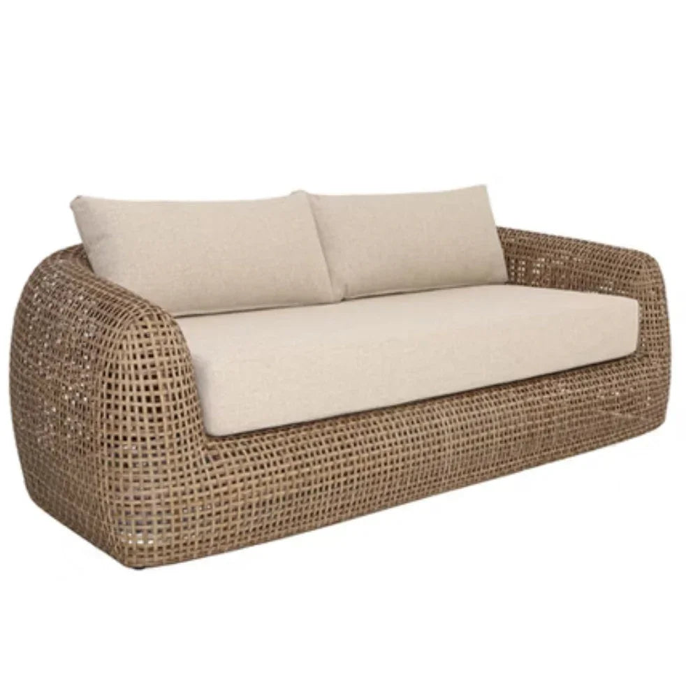 Coastal style woven rattan outdoor loveseat with cream cushions