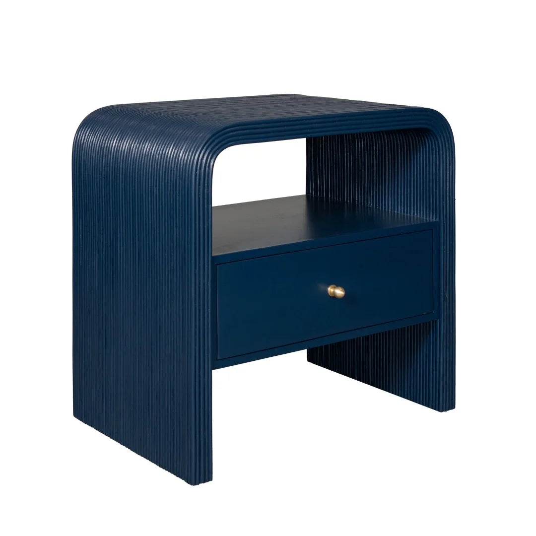 Navy blue fluted nightstand with a single drawer and gold knob in a modern coastal style.