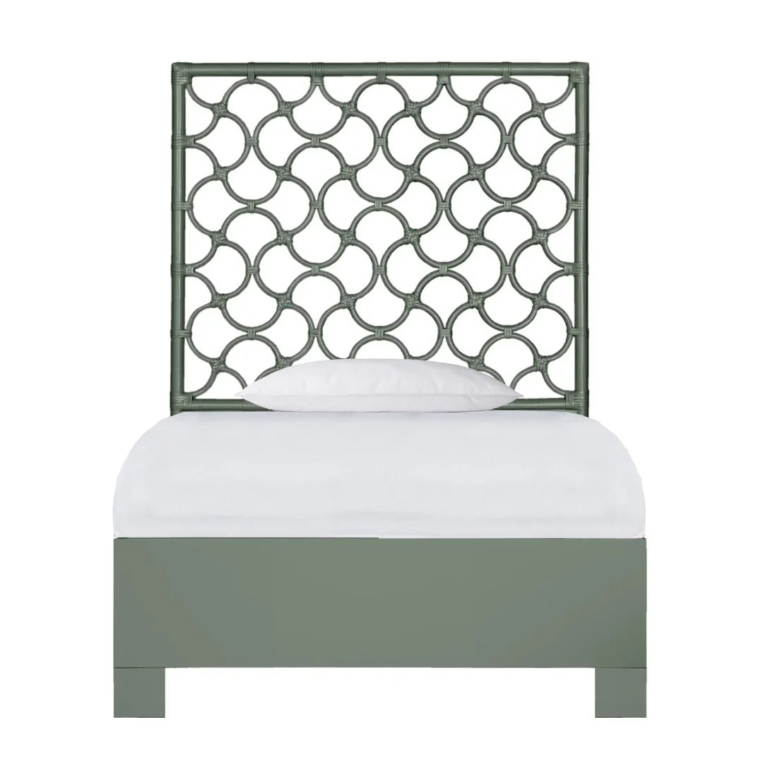 Sage green bamboo-style headboard and bed frame in a coastal boho style.
