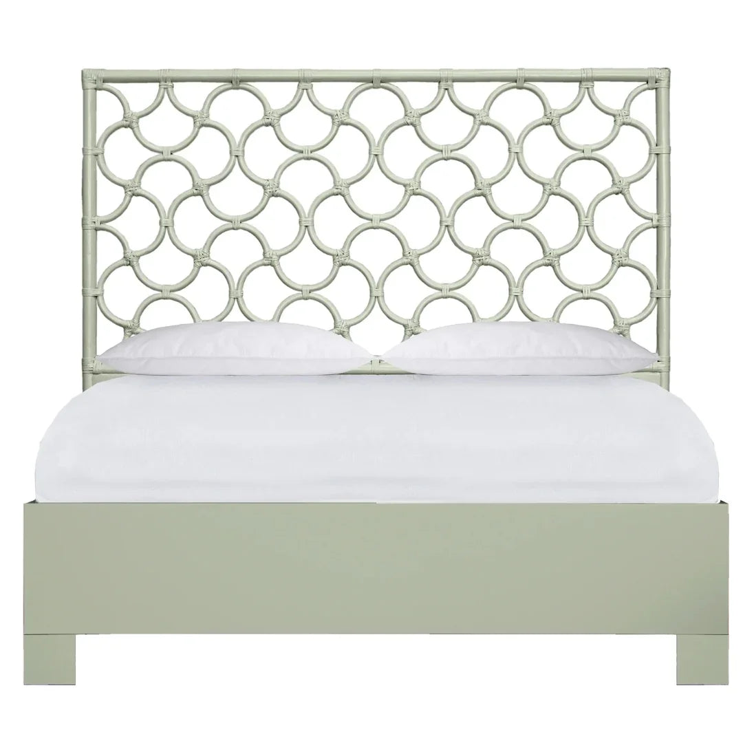 Sage green rattan headboard bed with interlocking circle design in coastal boho style.