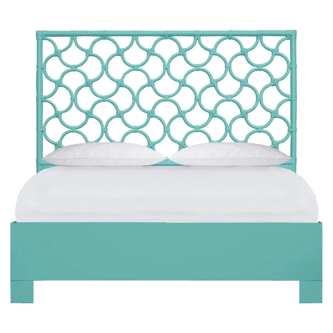 Turquoise rattan fretwork headboard bed frame in a coastal chic style with white bedding.