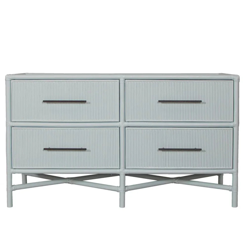 Light blue 4-drawer rattan dresser in coastal boho style with black metal handles.
