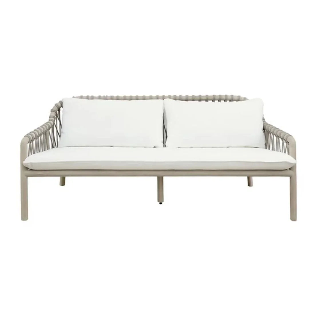 Coastal style outdoor sofa with white cushions and a light grey woven frame.