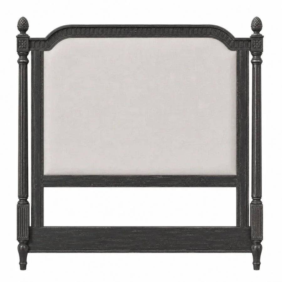 Black French country style upholstered headboard with ornate carved pillars.