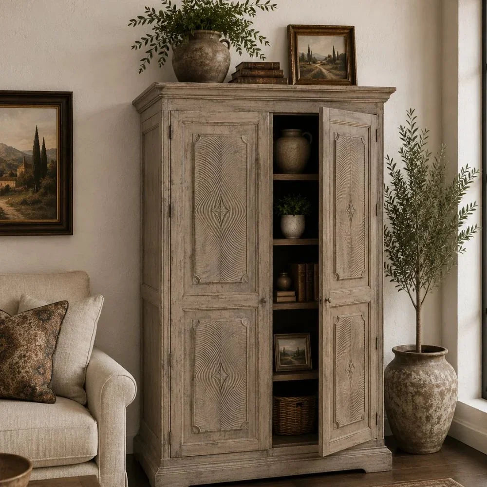 Weathered grey French country armoire with carved wood doors and open storage shelves.