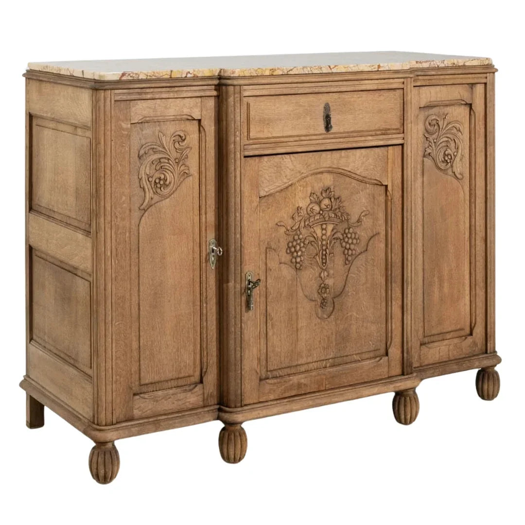 French country sideboard with carved grape motifs, marble top, and turned feet