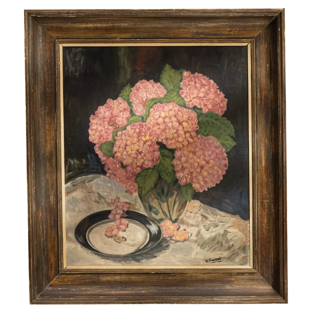 Oil painting of pink hydrangea flowers in a glass vase on a table, framed in dark wood.
