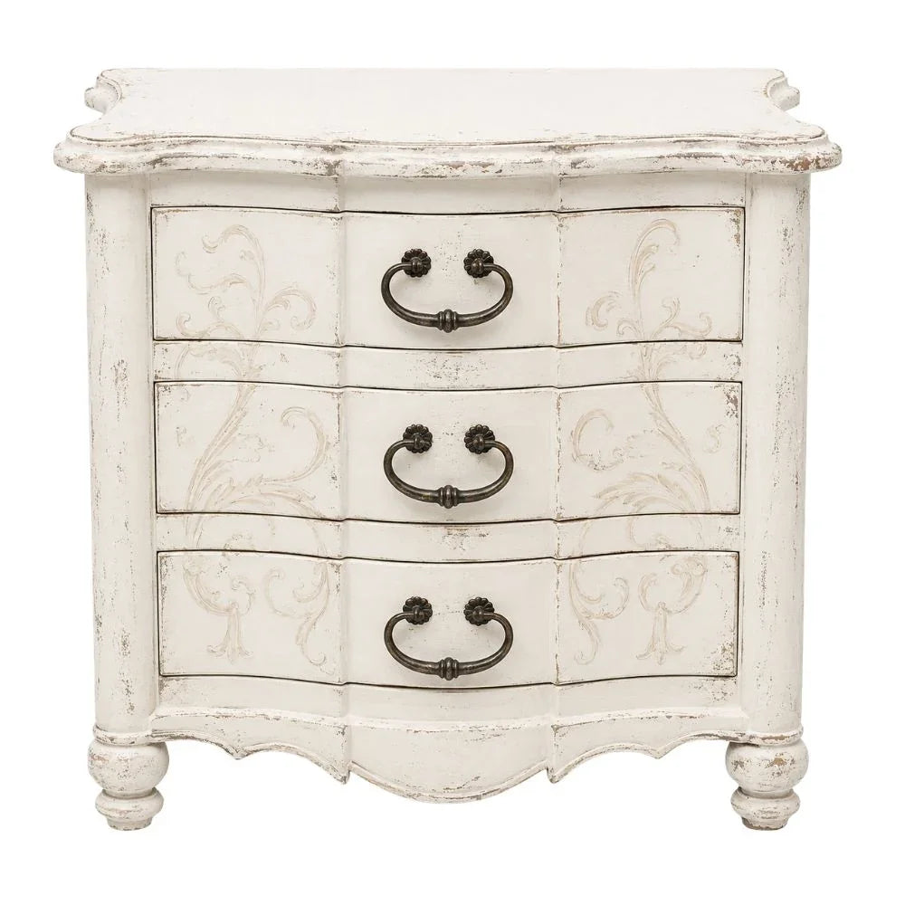 Shabby chic white 3-drawer nightstand with ornate carvings and dark metal handles.