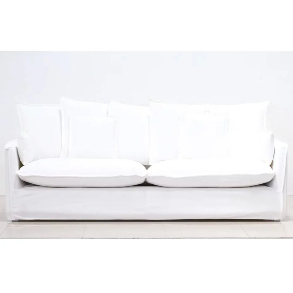 White slipcovered sofa with plush cushions, ideal for French country or farmhouse living rooms