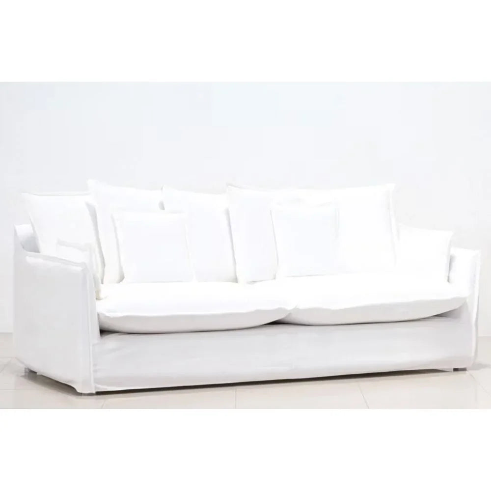 White slipcovered sofa with plush cushions, ideal for farmhouse or coastal living room decor