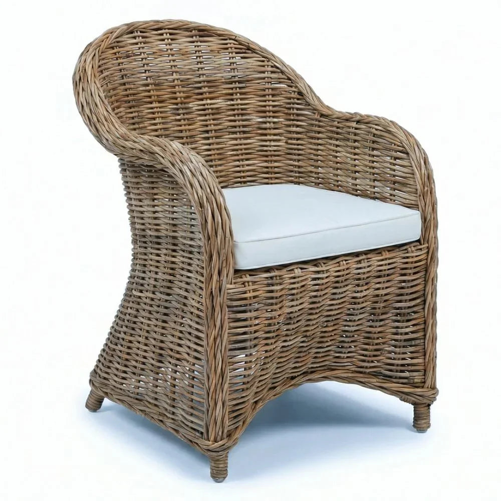 Woven wicker armchair with white cushion, coastal or farmhouse style seating