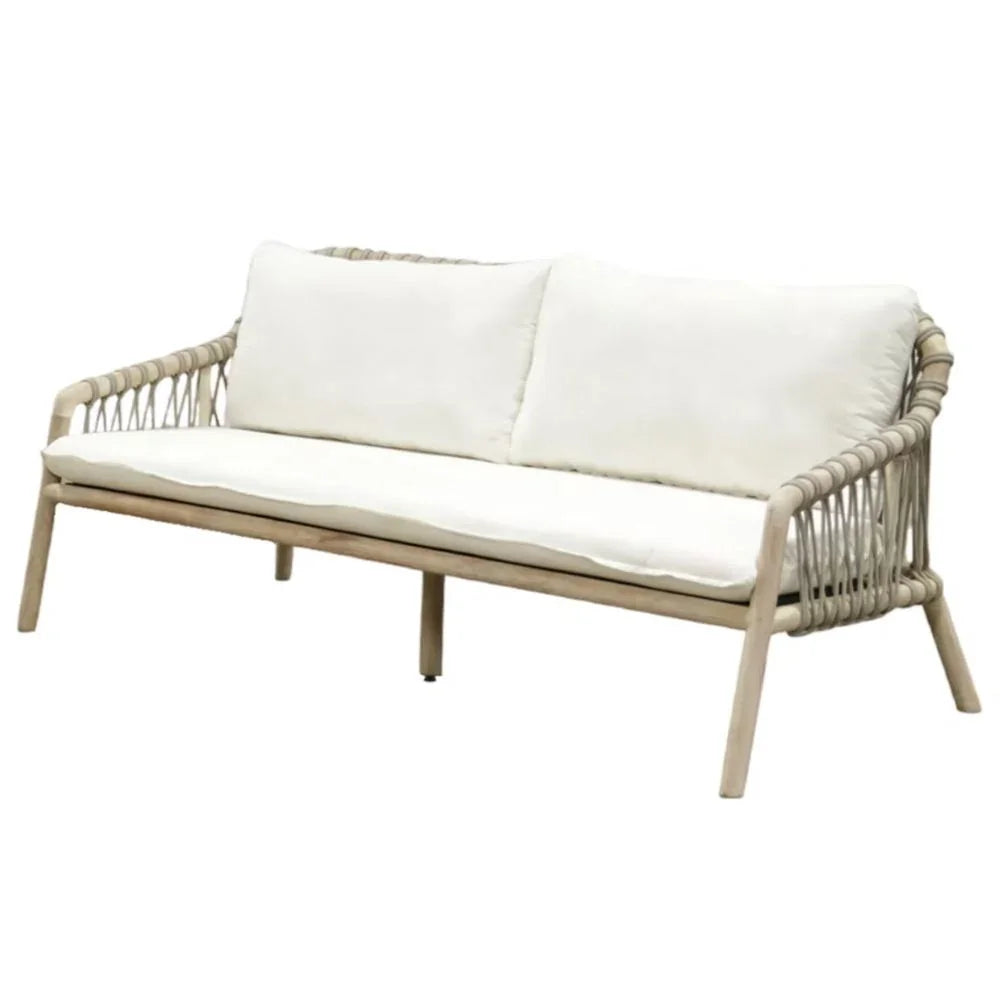 Coastal boho style outdoor sofa with white cushions and woven rope detail on a light wood frame.