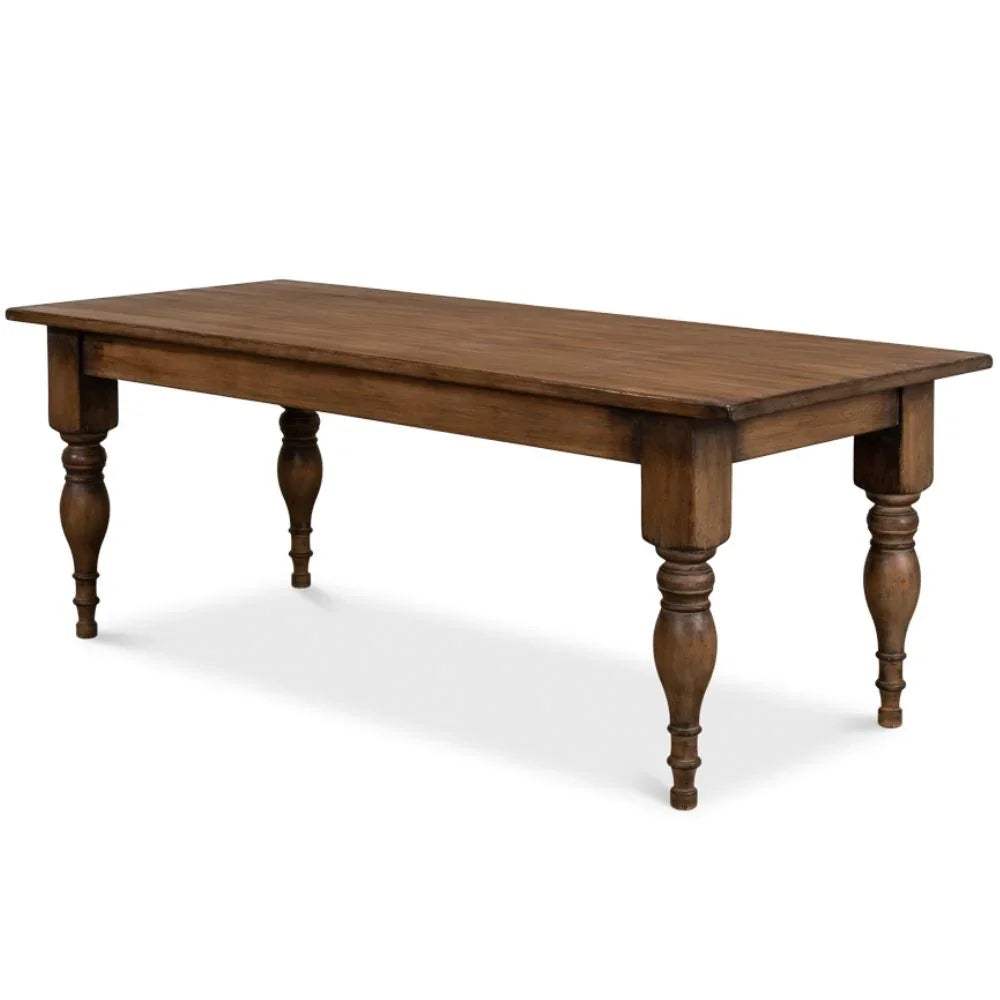 Rustic brown wood farmhouse dining table with turned spindle legs.