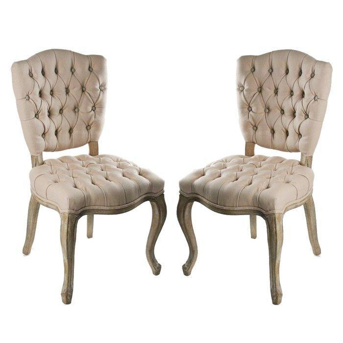 Elegant tufted dining chairs in French country style with distressed wood legs and neutral upholstery