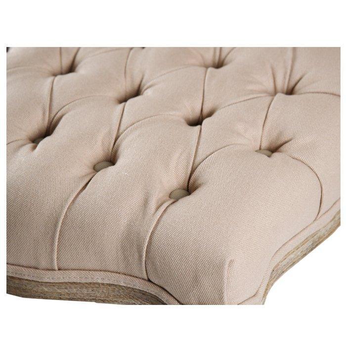 Beige tufted cushion with button detailing, ideal for French country or farmhouse furniture styles.