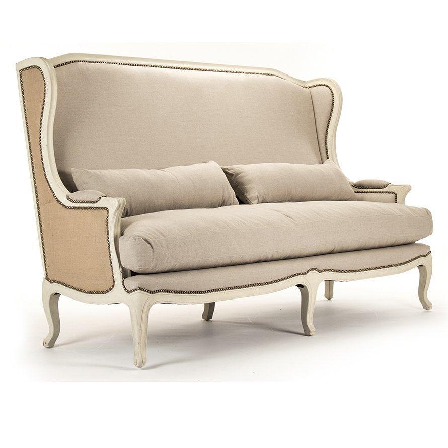 French country sofa with wingback design, nailhead trim, and curved legs in neutral linen fabric