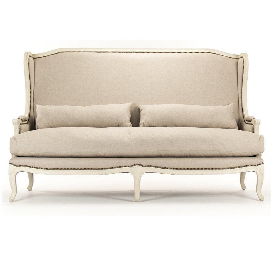 Elegant French country sofa with wingback design, neutral linen upholstery, and carved legs