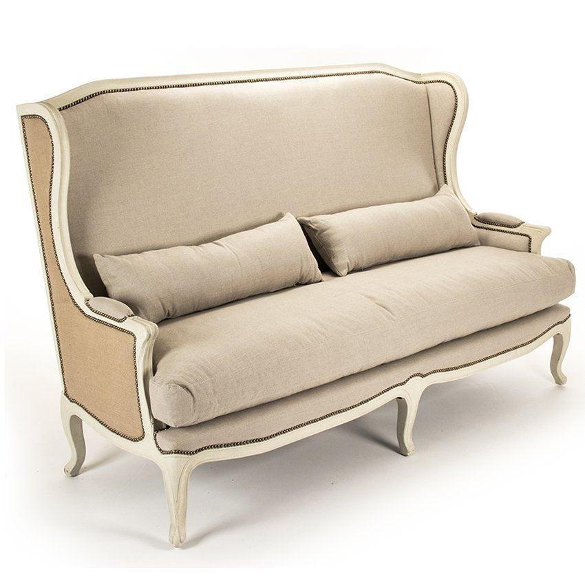Elegant French country sofa with cream upholstery, nailhead trim, and curved legs for shabby chic or farmhouse decor