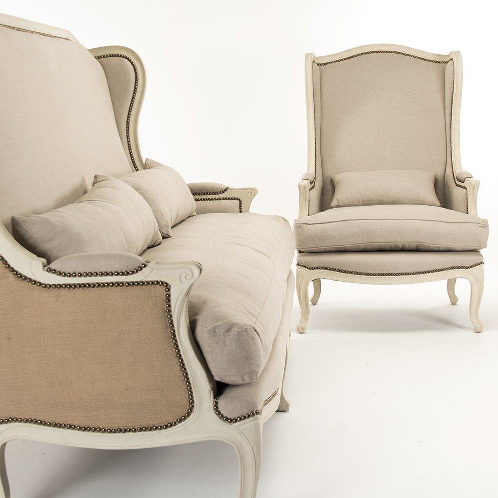 Elegant French country sofa and armchair with nailhead trim in neutral tones