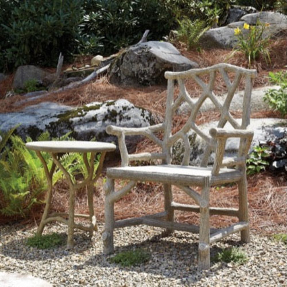 Rustic branch-style outdoor chair and side table set in natural boho garden setting