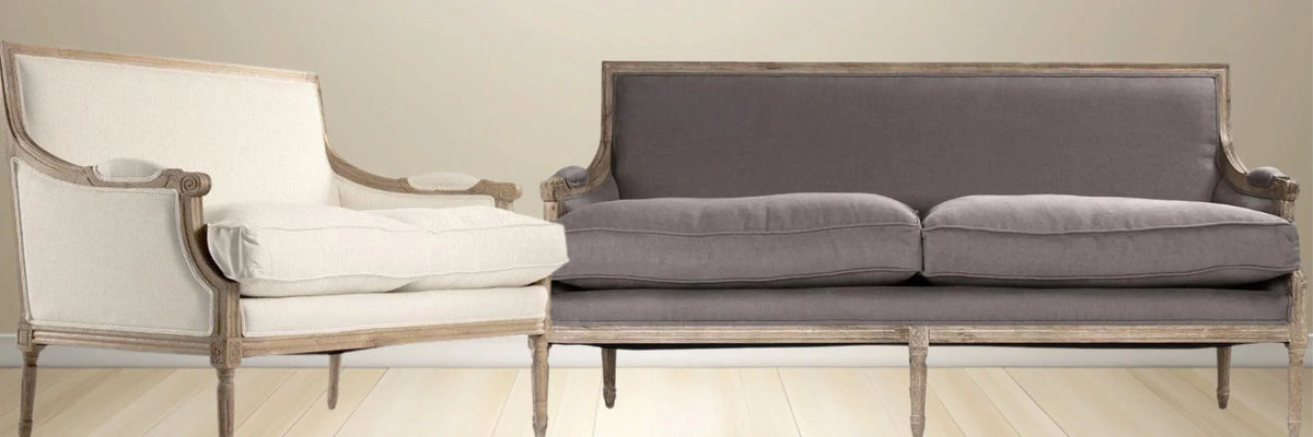 French country sofa and armchair set with distressed wood frame and neutral upholstery
