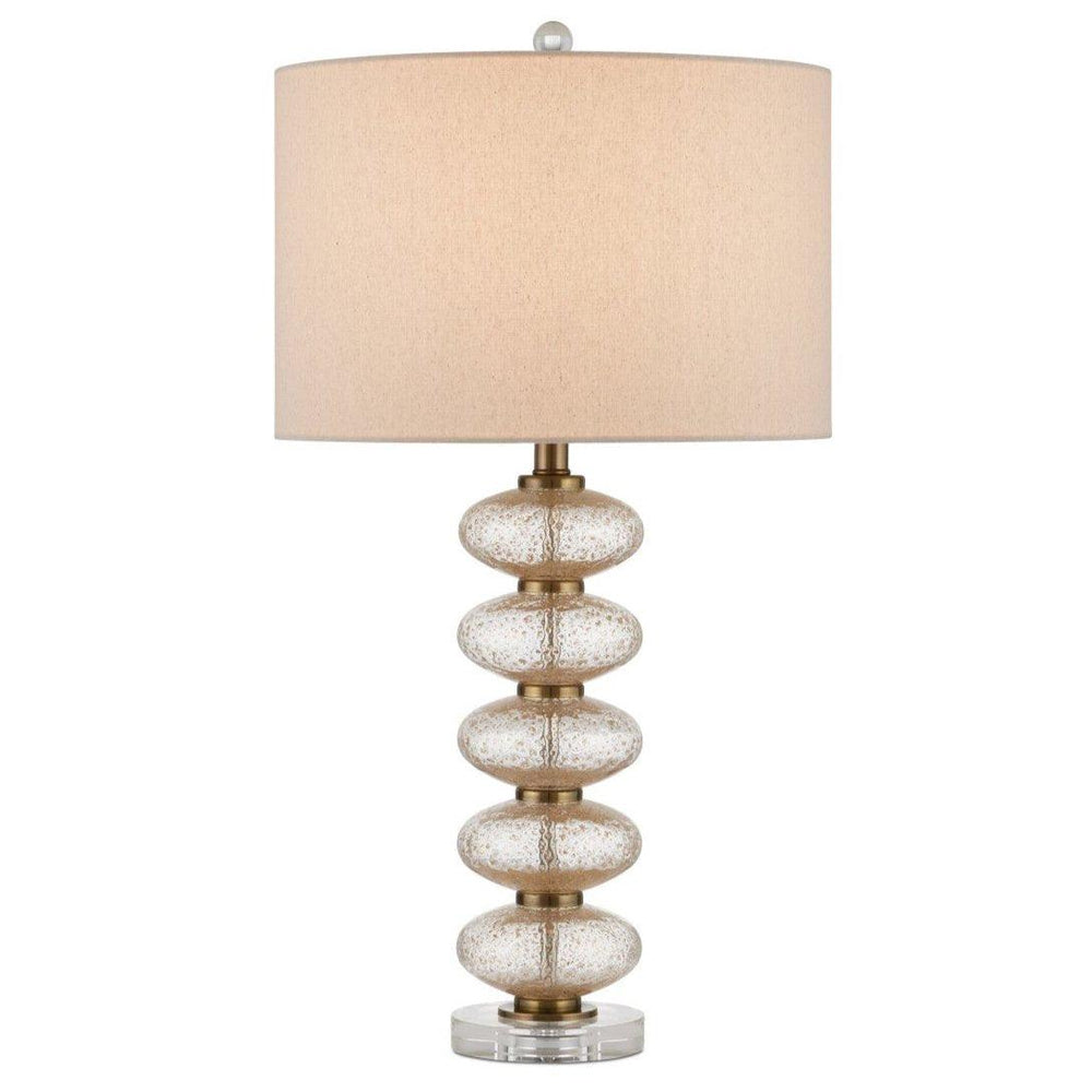 Modern coastal table lamp with a textured gold glass base and a neutral linen drum shade.