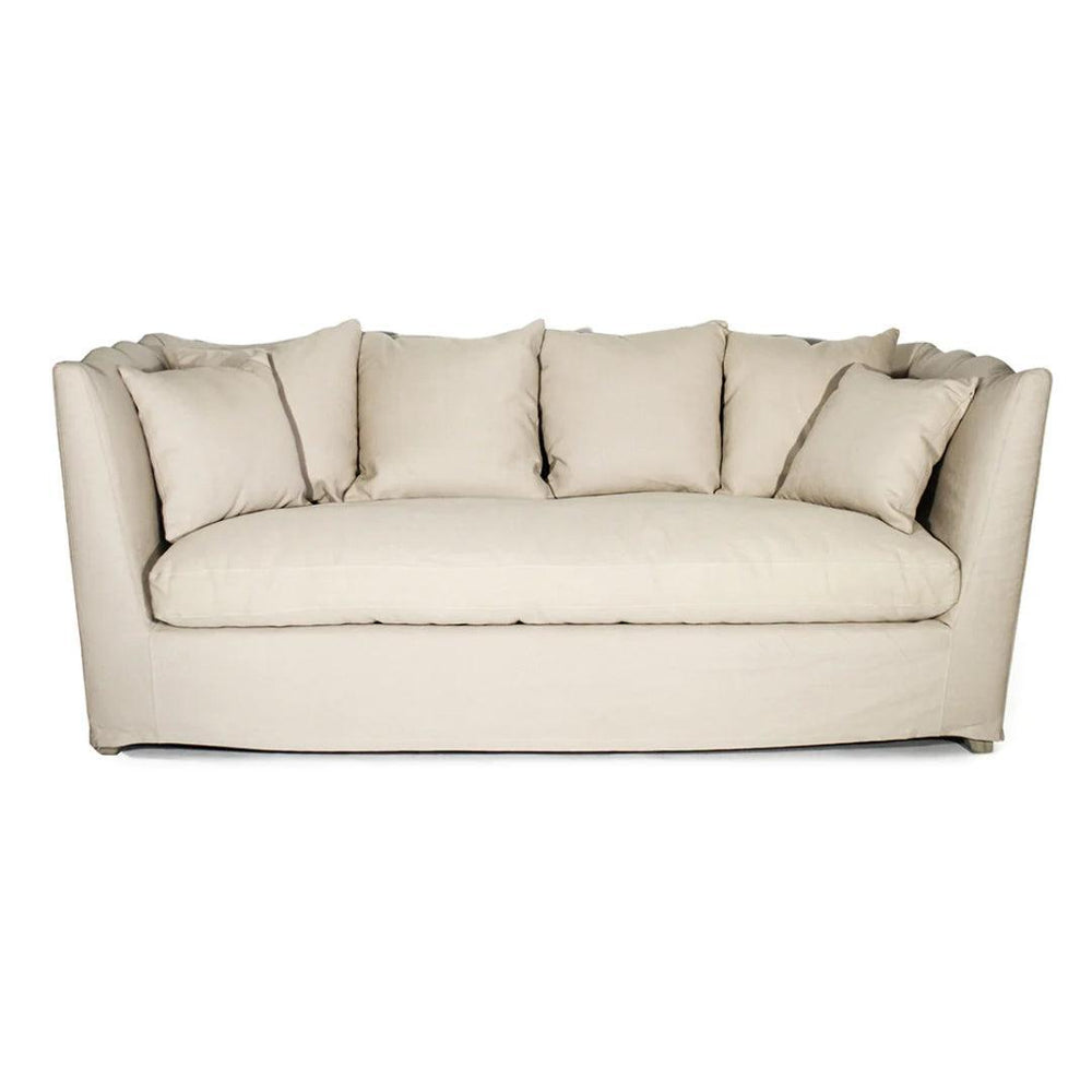 Cream slipcovered French country sofa with plush back cushions and a tailored skirt.