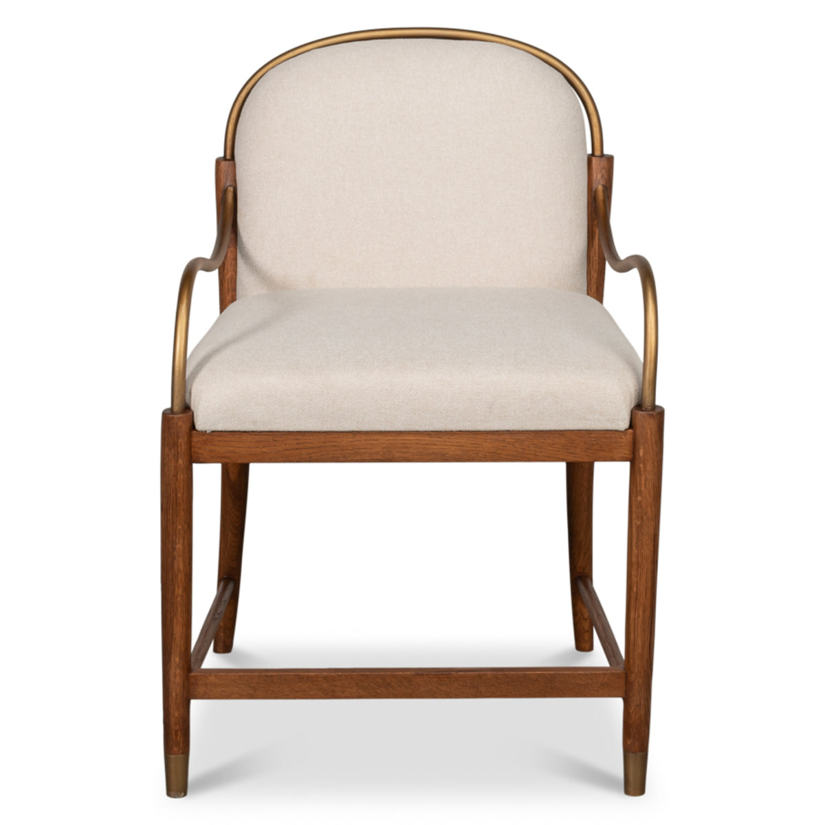 Aurelle oak dining chair with tan upholstery, curved backrest, brass-finished metal arms, and tapered wooden legs.