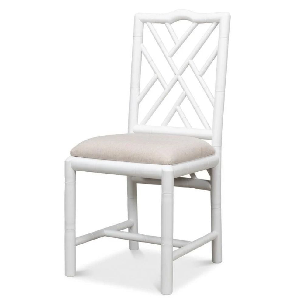 White bamboo-style dining chair with beige cushion, perfect for coastal or farmhouse decor