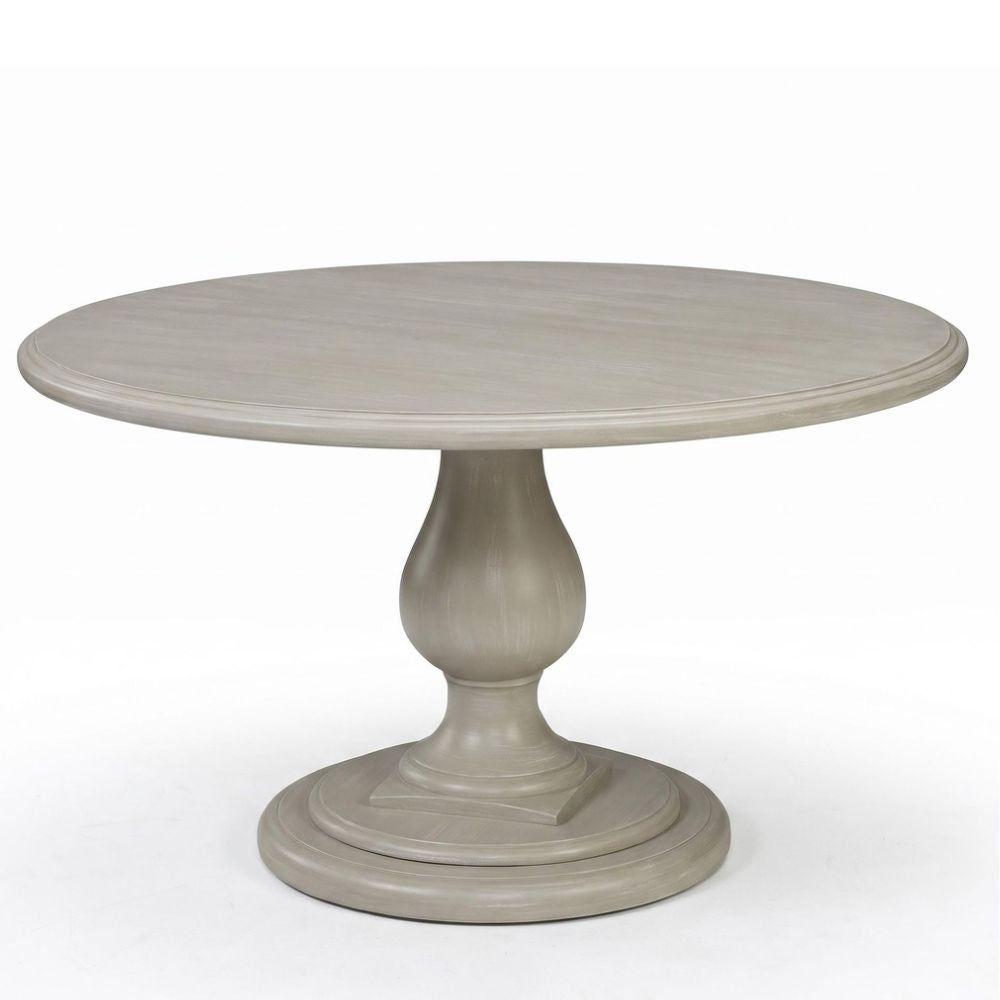 A round pedestal dining table with a distressed gray finish, featuring a smooth circular tabletop and a sculptural turned base, shown on a white background.
