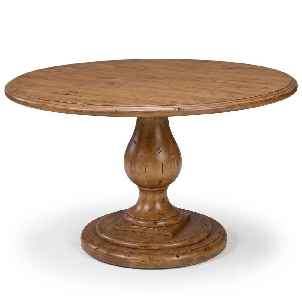 A round wooden dining table with a turned pedestal base, featuring a warm medium brown finish and visible wood grain, shown on a white background.